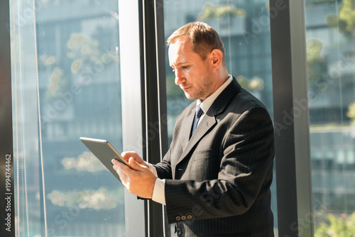 Business man using tablet n...