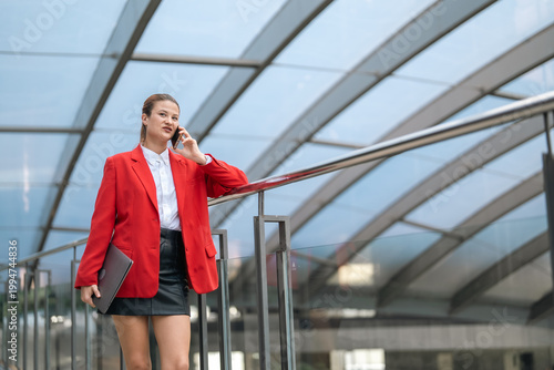 Young woman in red blazer u...