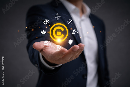 Obraz na płótnie Businessman holding copyright symbol represent intellectual property protection, copyright monitoring, digital rights management, legal compliance and content ownership security