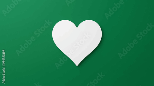 A white heart shape on a green background