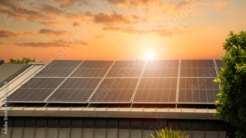 Fotografie Solar panels on the metal roof of a modern house under a clear blue sky with sunlight