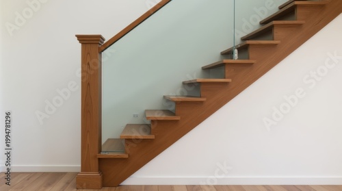 Solid newel post stairs with wooden treads and transparent glass railing held by steel frames 
