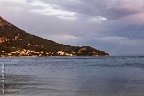 Zivogosce harbor and promenade at sunset over the Adriatic Sea, photographed from Igrane in late summer