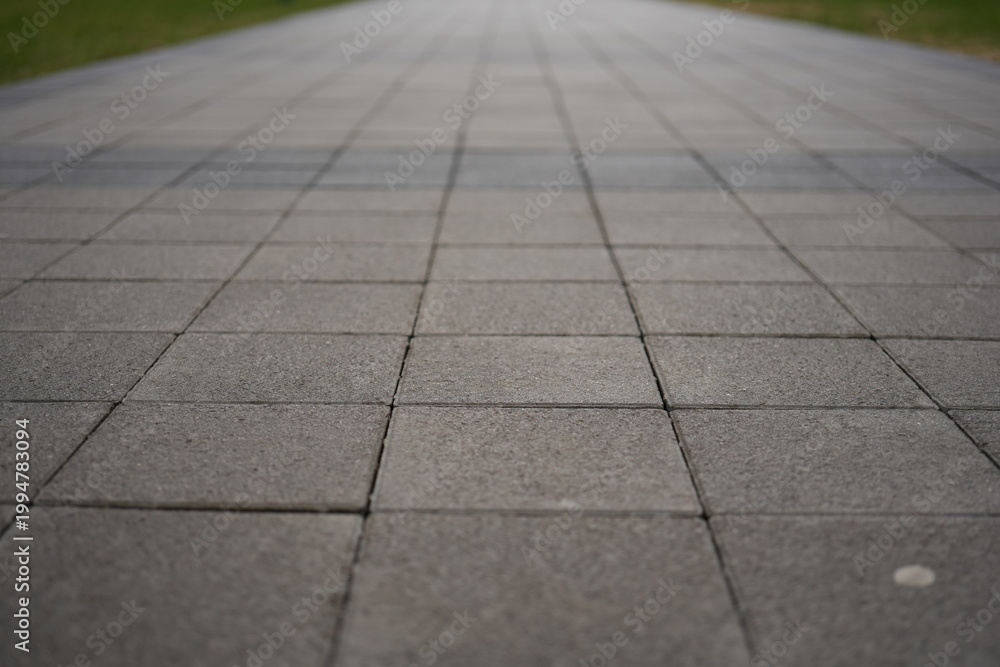 Fototapeta premium grey paving tile texture, grey tile pattern as background, grey tile texture close up 