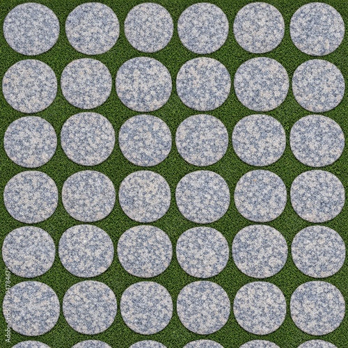 A repetitive pattern of circular light stone tiles arranged on a well-maintained lush green grass background, creating a modern outdoor design.