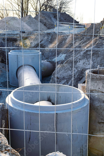 Installation of concrete manhole rings for sewage and drainage system in a trench