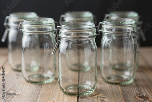Row of Glass Jars on Wooden Surface