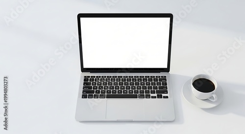 Modern Laptop with Coffee Cup on White Desk.
