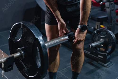 Tableau sur toile Athlete Preparing for a Barbell Deadlift in a Modern Gym, Man Getting Ready for Deadlift During Strength Training Session