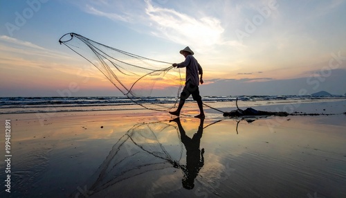 Fisherman casting net at golden sunset beach with reflective wet sand