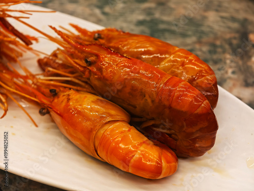 Close-up of several cooked prawns on plate