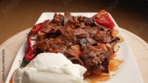 Delicious traditional Turkish Iskender Kebab rotating, served with tomato, yogurt, and grilled pepper, fa01