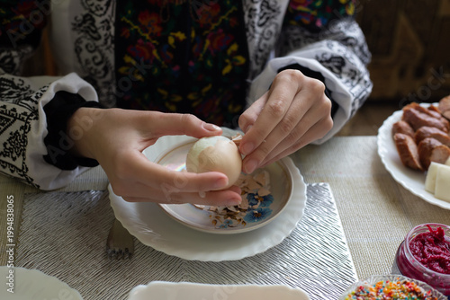 A boiled chicken egg, peeled from the shell. On the festive table.
