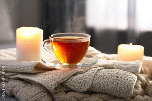 Warm Cup of Tea on a Cozy Blanket With Lit Candles in a Soft Setting