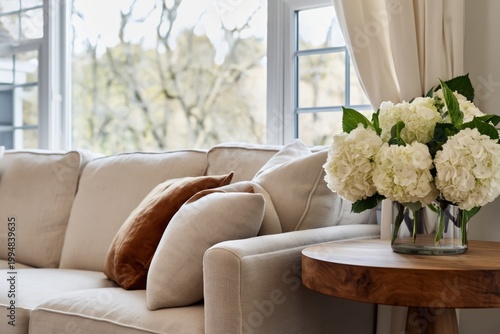 Cozy Living Room With a Neutral Sofa and a Vase of Flowers on a Wooden Table