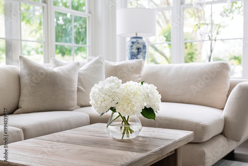 Cozy Living Room With a Neutral Sofa and a Vase of Flowers on a Wooden Table