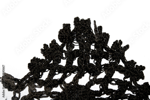Close up of vintage black gothic lace fabric white on black background embroidery