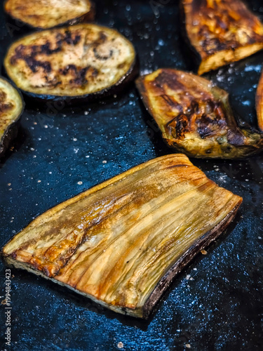 close view of a few grilled  hot eggplant slices