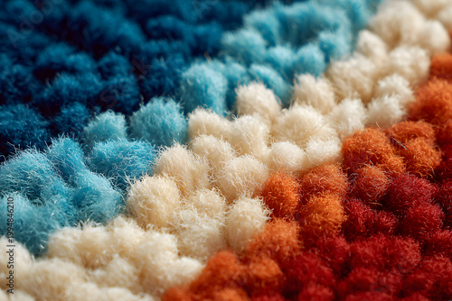 knitting wool texture in red, beige, blue colors. punch needle work, close up