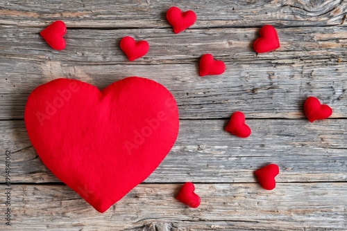 Red Heart Cushion With Smaller Hearts on Wooden Table for Decoration