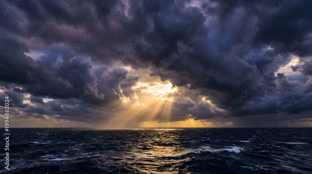 Fototapeta premium Dramatic sunbeams breaking through dark storm clouds over ocean waves.