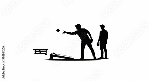 Silhouette of two people playing cornhole, one tossing a beanbag