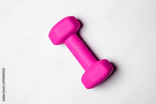 Bright Pink Dumbbell Placed on a White Surface for Fitness and Exercise Routines