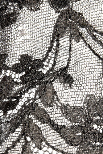 Close up of vintage black gothic lace fabric white on black background embroidery