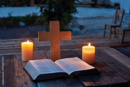 Candles and a Bible on a Wooden Table With a Cross in a Dimly Lit Setting