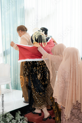 Traditional Javanese Wedding Sinduran Ceremony with Bride and Groom