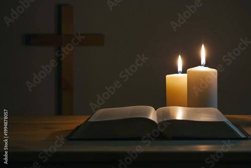 Candles and a Cross on an Open Bible on a Wooden Table in a Dim Room