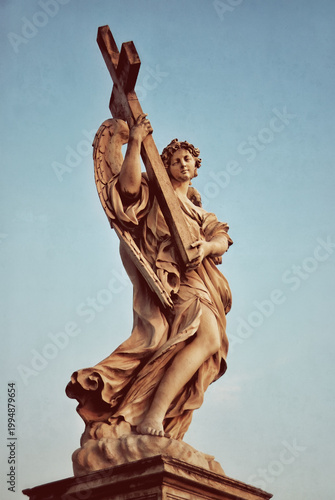 Angel with a cross on the Ponte Sant'Angelo. Rome, Italy