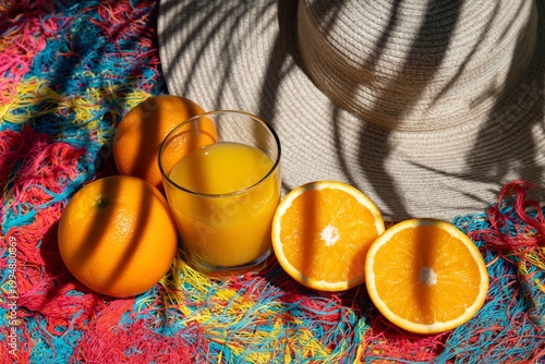 Enjoying Fresh Oranges and Juice on a Colorful Blanket in Bright Sunlight Wit...