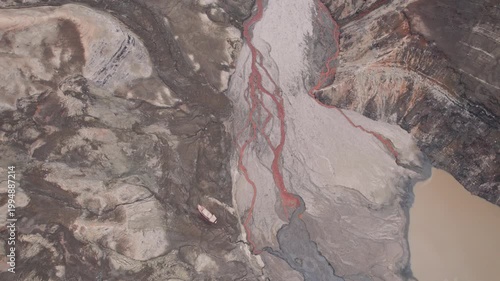 Abstract textures on the drained reservoir floor at Vidraru Dam with mineral patterns and sediment layers	