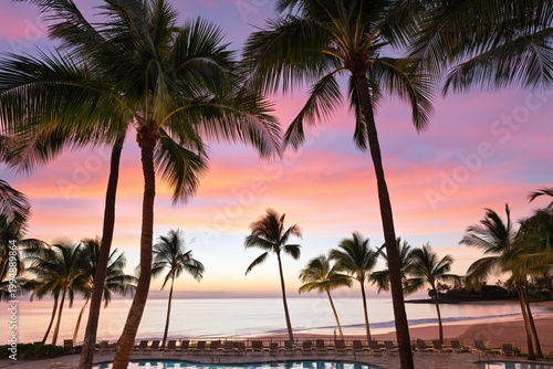 Sunset View Over Pool and Beach Surrounded by Palm Trees in Tropical Resort