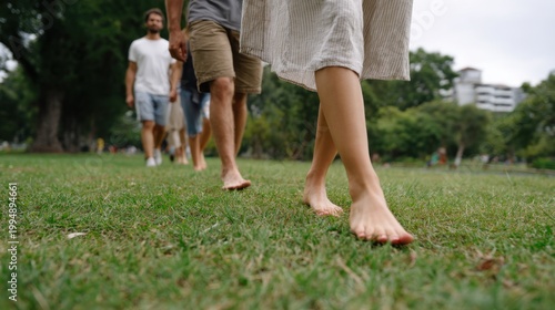 People walking barefoot on grass in park enjoying nature mindfulness and peace 