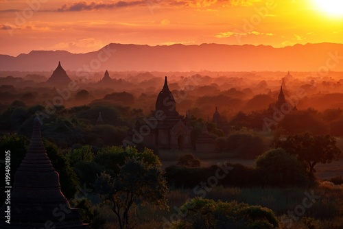 Sunset Over Ancient Temples in Bagan, Myanmar With Trees and Mountains in the...