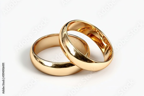 Two simple, gold wedding bands intertwined on a clean white surface