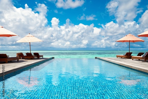 Poolside View With Sun Loungers and Umbrellas by the Ocean on a Bright Day