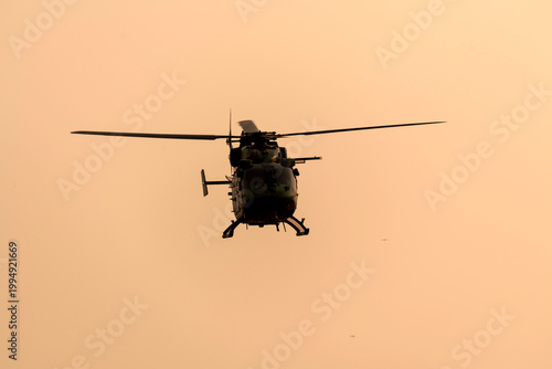 Silhouette Military helicopter air attack during dawn isolated sky