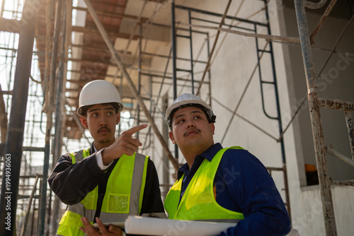 Construction project planning worksite team collaboration urban setting close-up view professional guidance