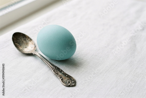 Cyan Egg and Vintage Spoon on White Fabric, Still Life, Easter Holiday Concept, Minimalist, Rustic, Delicate, Natural Light