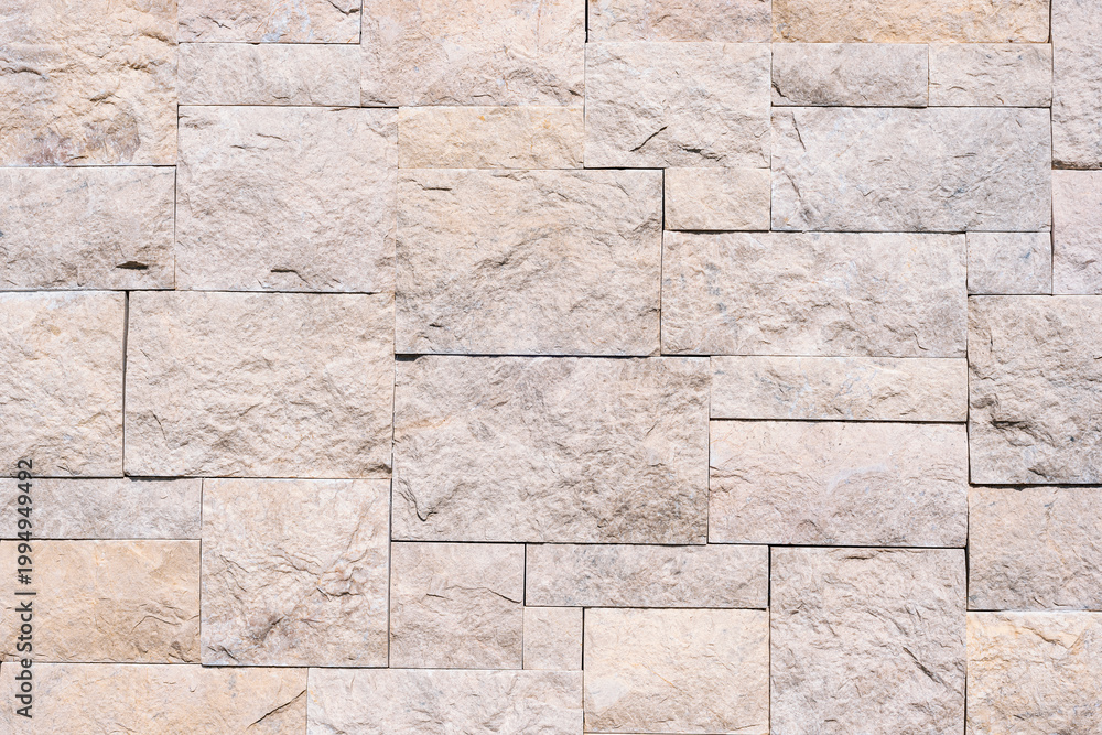 Fototapeta premium Beige stone wall background, texture