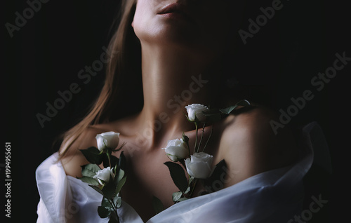 A romantic photo of a woman's cleavage and white roses. Concept of beauty, creativity, and fashion