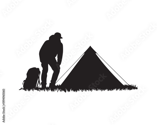 Silhouette of a person with a backpack next to a pyramid tent on grass camping