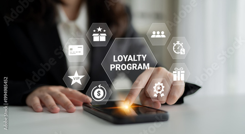 Konstfotografi A business professional interacts with a smartphone displaying a loyalty program interface