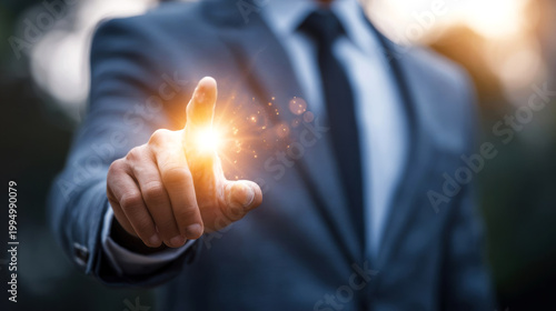 Businessman in a suit extends his hand with a glowing light effect, suggesting innovation and technology in a blurred outdoor setting during sunset