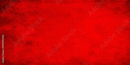 A dark and distressed vintage red grunge texture with an aged, grungy pattern on a dirty surface makes a perfect material backdrop for a Christmas card or old wallpaper design