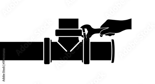 Hand using wrench to tighten a pipe fitting connection