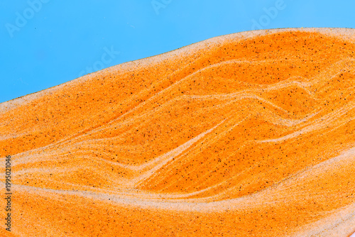 Detailed abstract texture layered orange and white sand, creating organic wavy patterns and marble effects.